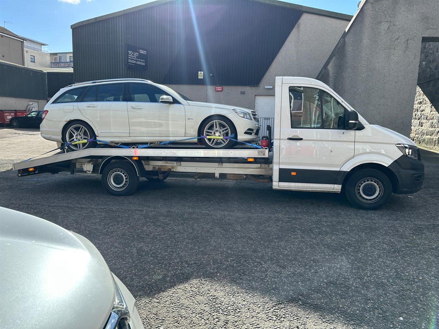ZRG truck carrying a white estate car